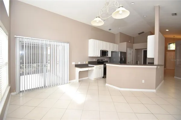a kitchen with stainless steel appliances a refrigerator sink and cabinets