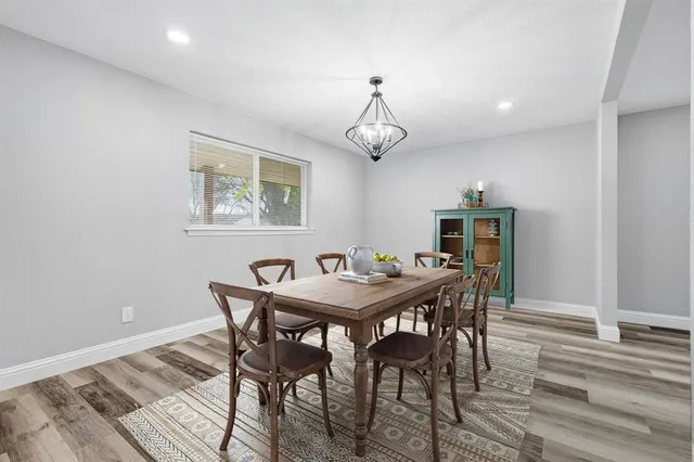 a living room with furniture a fireplace and a chandelier