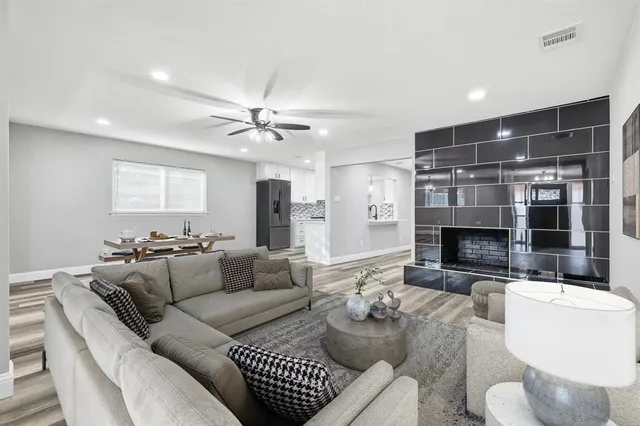 a living room with a table and a bookshelf