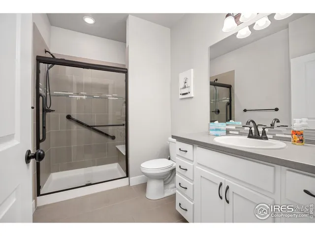 a bathroom with a sink vanity mirror and toilet