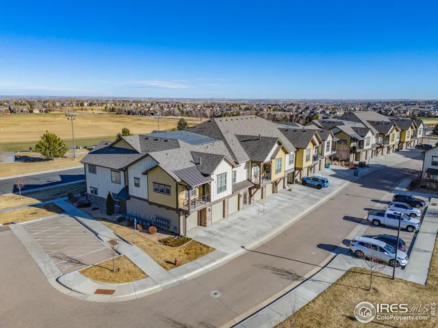 an aerial view of a house with outdoor seating