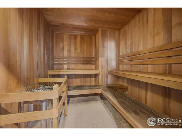a view of a room with wooden floor and cabinet