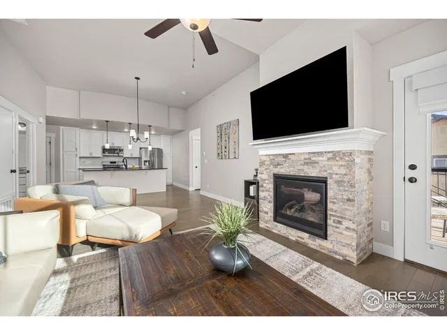 a living room with furniture a flat screen tv and a fireplace