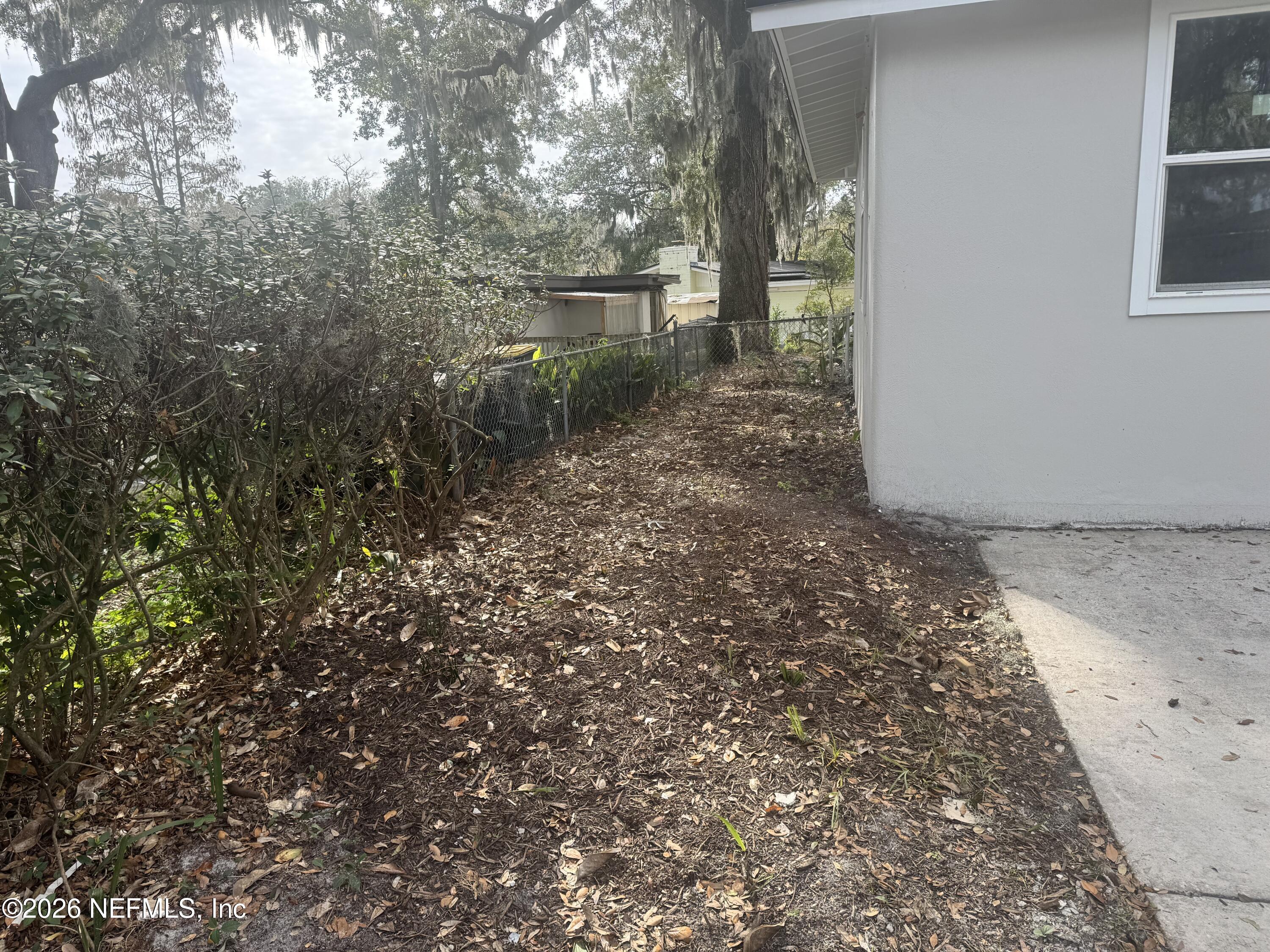 1718 Cornell Road Jacksonville, FL 32207 - Photo 9 of 41 a view of a yard with plants and large trees