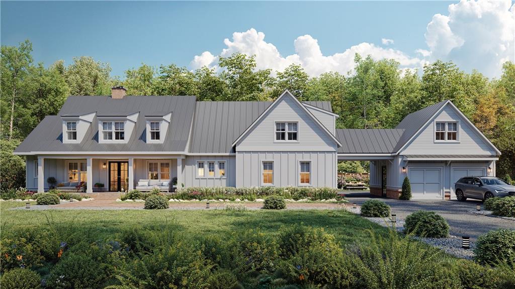 a front view of a house with a yard and trees