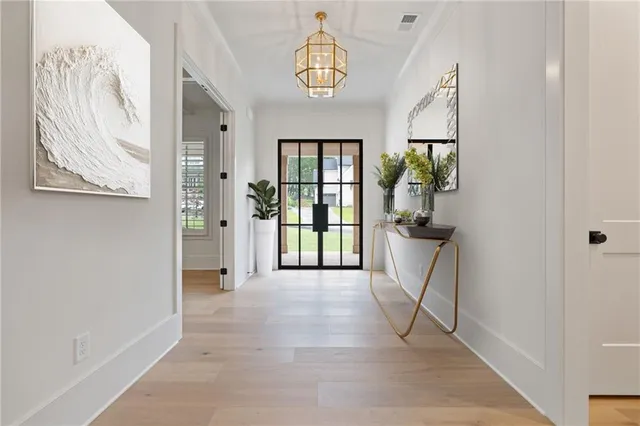 a view of hallway with furniture and a window