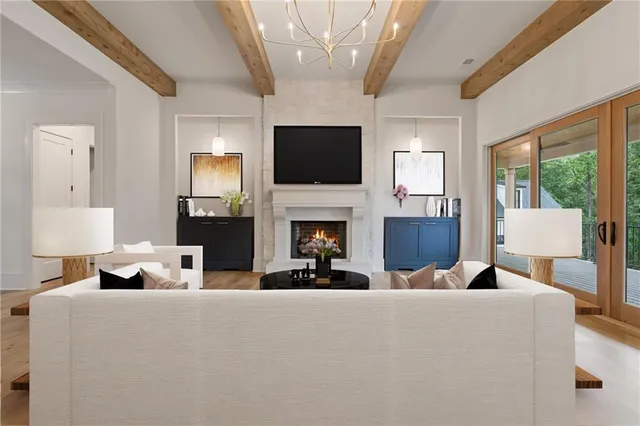 a living room with furniture a flat screen tv and a fireplace