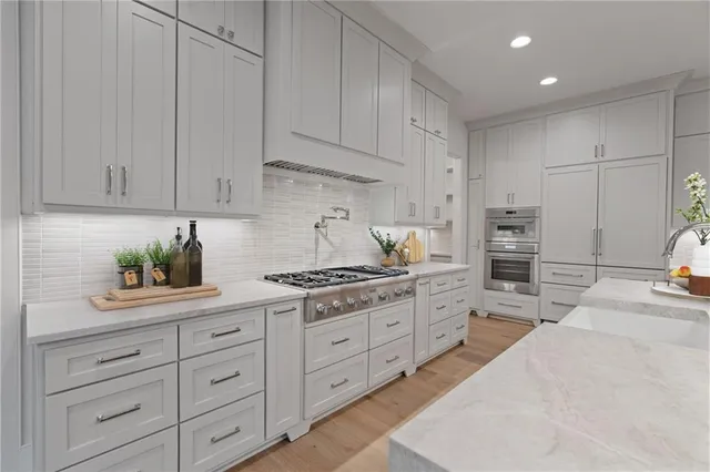 a kitchen with cabinets appliances and a counter top