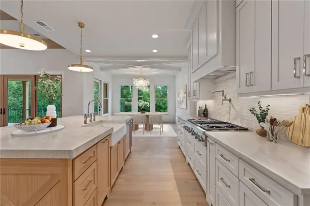 a kitchen with stainless steel appliances a sink stove and cabinets
