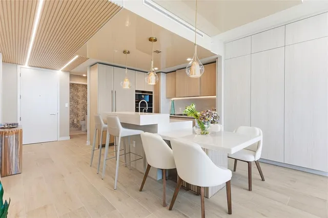 a view of a hallway with wooden floor and entryway