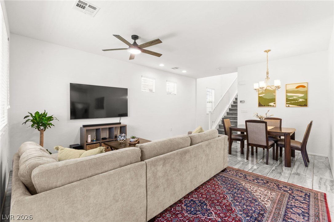 6435 Point Isabel Way Las Vegas, NV 89122 - Photo 9 of 57 An inviting open-concept living space features stylish lighting and durable flooring.