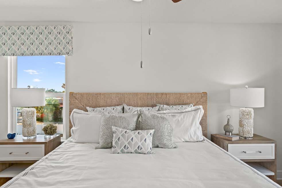 11 Renea Cove Destin, FL 32541 - Photo 17 of 30 a bedroom with a bed and a lamp