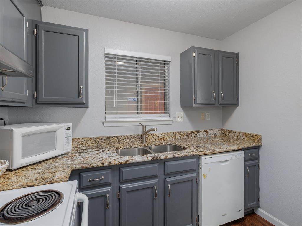 3004 Speedway, Unit 6 Austin, TX 78705 - Photo 11 of 25 a kitchen with stainless steel appliances granite countertop a sink stove and cabinets