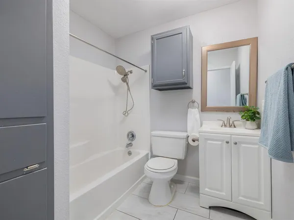 a bathroom with a toilet a sink and bathtub