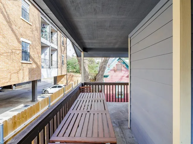 a view of balcony with wooden floor and iron gate