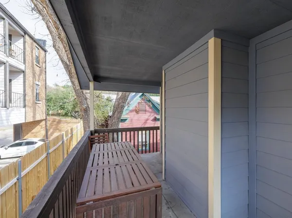a view of balcony with wooden floor