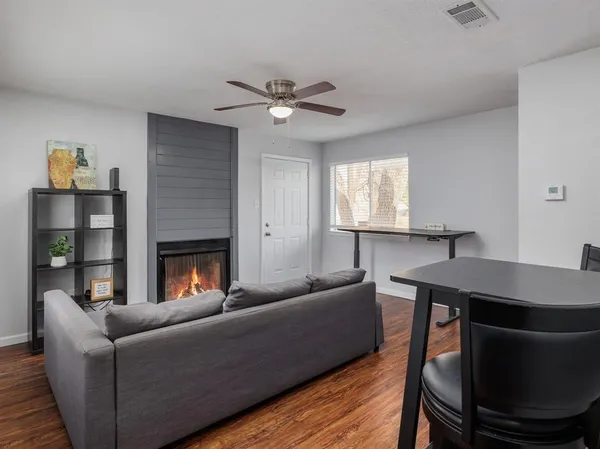 a living room with furniture and a fireplace