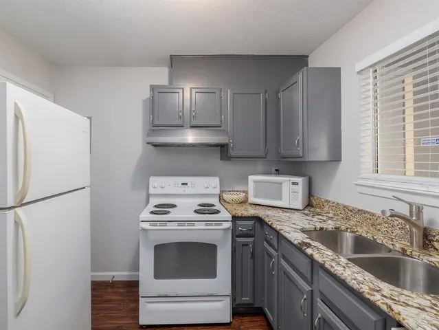 a kitchen with stainless steel appliances a stove a sink and a refrigerator