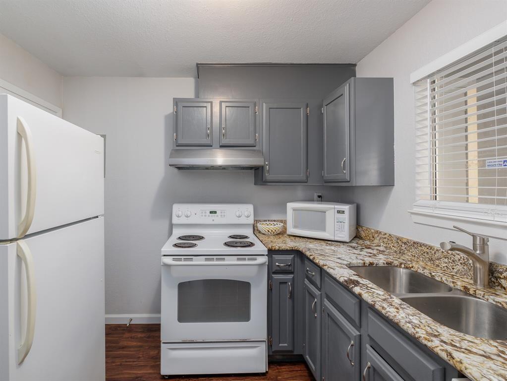 3004 Speedway, Unit 6 Austin, TX 78705 - Photo 10 of 25 a kitchen with stainless steel appliances a stove a sink and a refrigerator