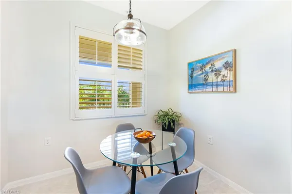 a dining room with furniture and window