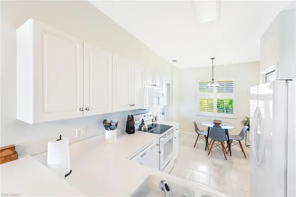 a kitchen with stainless steel appliances kitchen island granite countertop a sink and cabinets