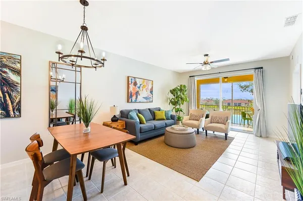 a living room with furniture a window and a chandelier