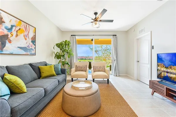 a living room with furniture and a large window