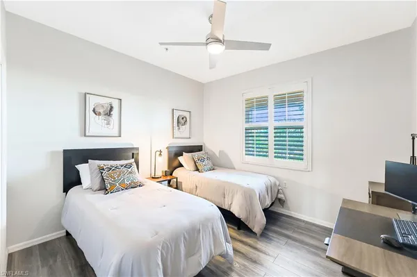 a bedroom with two beds and a flat screen tv