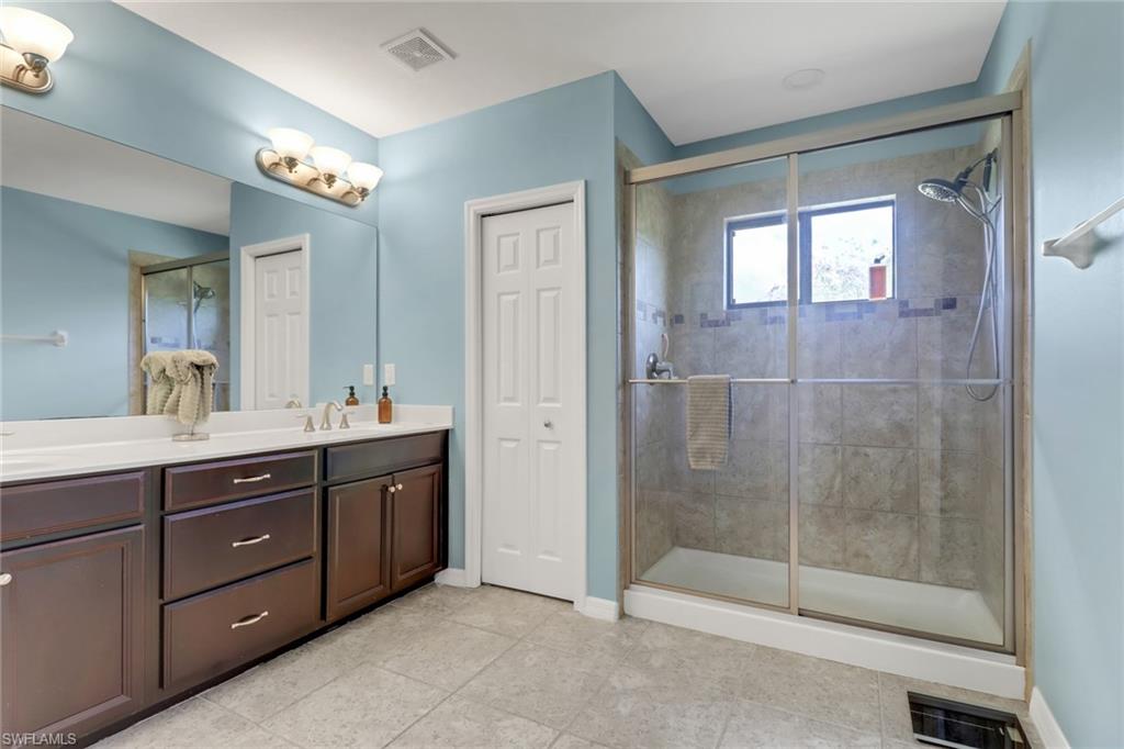 15354 Summit Pl Circle, Unit 159 Naples, FL 34119 - Photo 17 of 27 a bathroom with a sink and a mirror