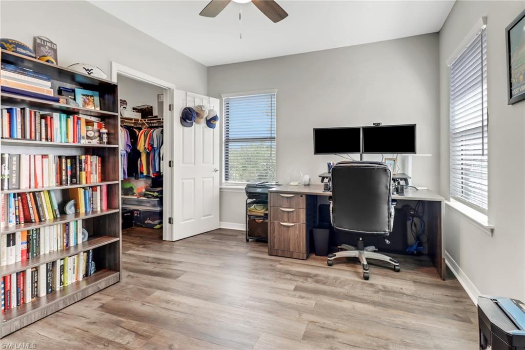15354 Summit Pl Circle, Unit 159 Naples, FL 34119 - Photo 21 of 27 a view of a workspace with furniture and a book shelf