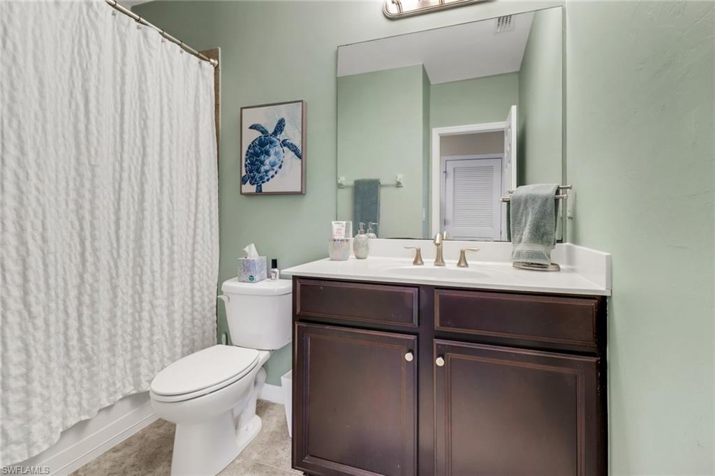 15354 Summit Pl Circle, Unit 159 Naples, FL 34119 - Photo 22 of 27 a bathroom with a sink mirror and toilet