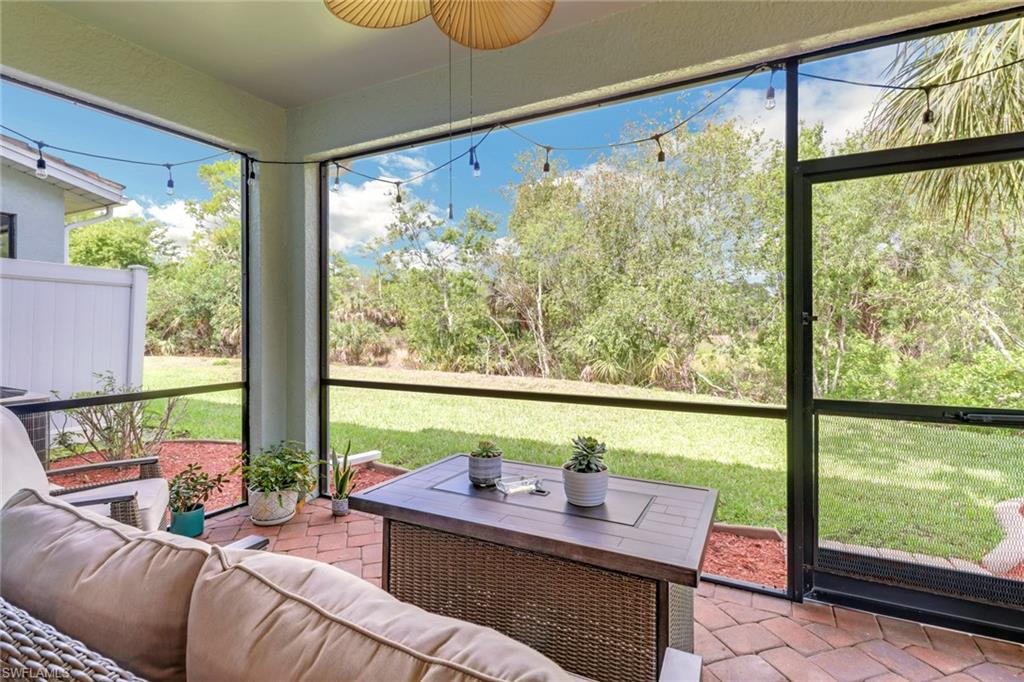 15354 Summit Pl Circle, Unit 159 Naples, FL 34119 - Photo 25 of 27 a living room with large windows
