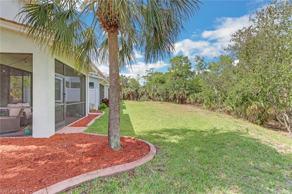 15354 Summit Pl Circle, Unit 159 Naples, FL 34119 - Photo 27 of 27 a view of a backyard with plants and palm tree