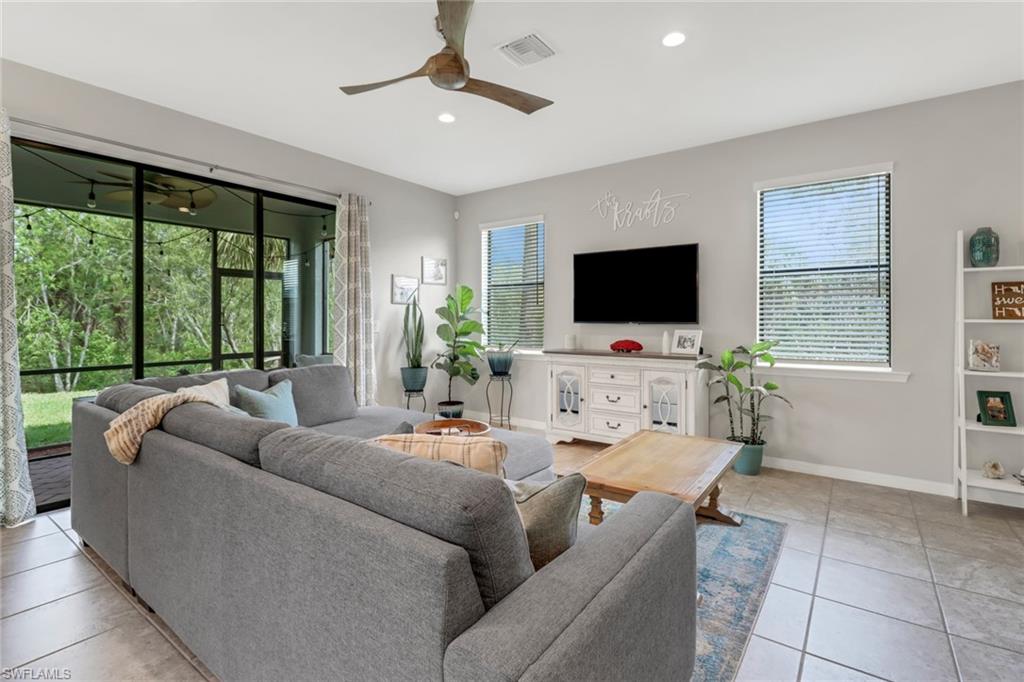 15354 Summit Pl Circle, Unit 159 Naples, FL 34119 - Photo 4 of 27 a living room with furniture and a flat screen tv
