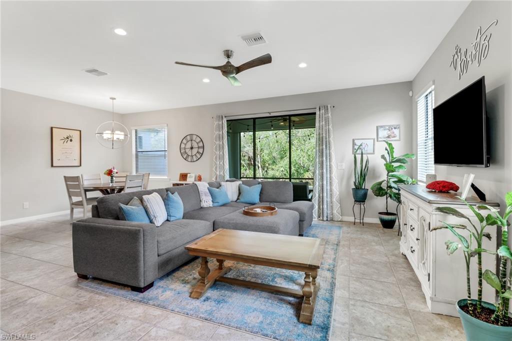 15354 Summit Pl Circle, Unit 159 Naples, FL 34119 - Photo 5 of 27 a living room with furniture and a flat screen tv