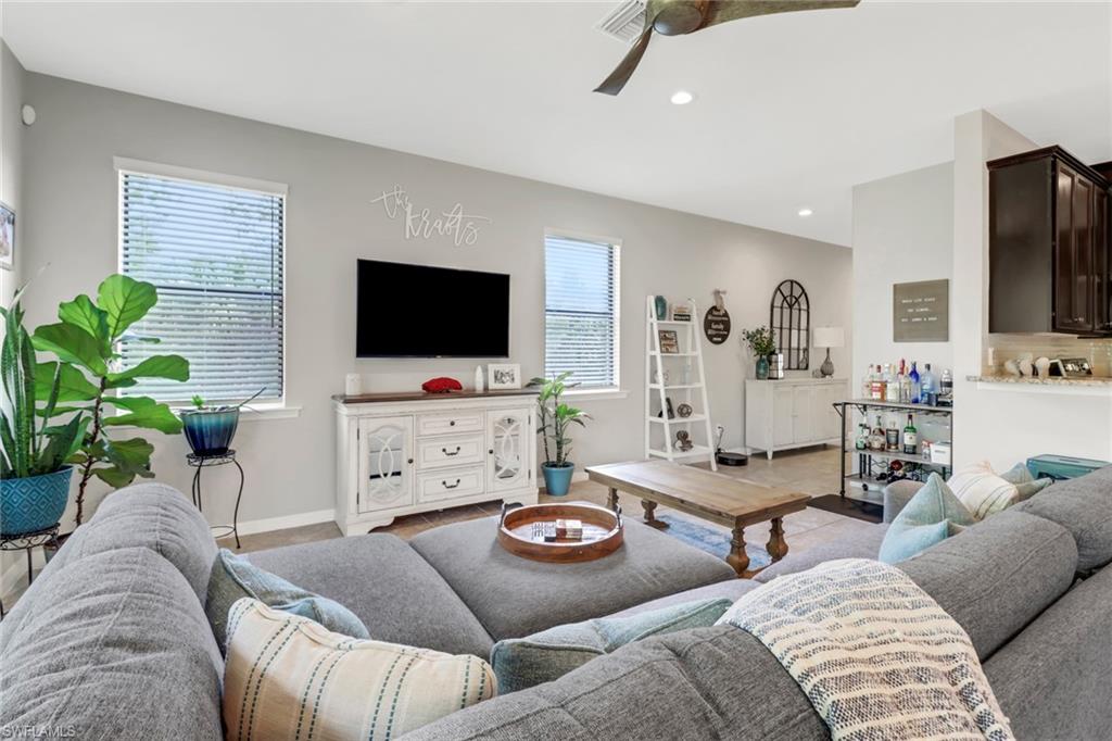 15354 Summit Pl Circle, Unit 159 Naples, FL 34119 - Photo 6 of 27 a living room with furniture and a flat screen tv