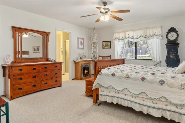 a spacious bedroom with a bed and a chandelier