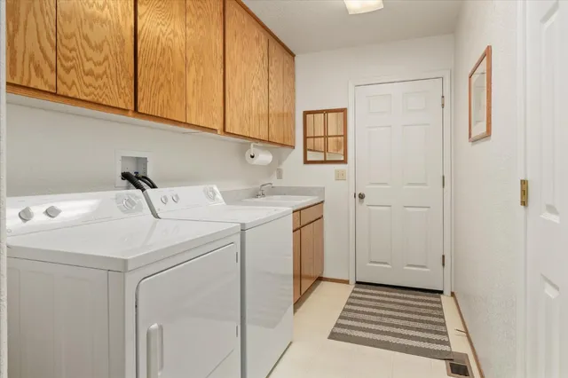 a view of a chairs and table in the backyard