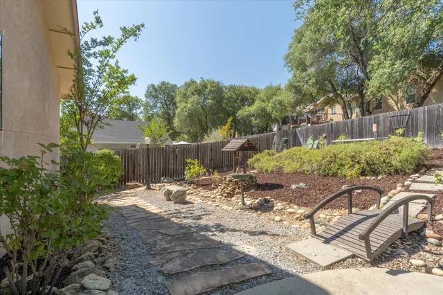 a view of a backyard with wooden fence