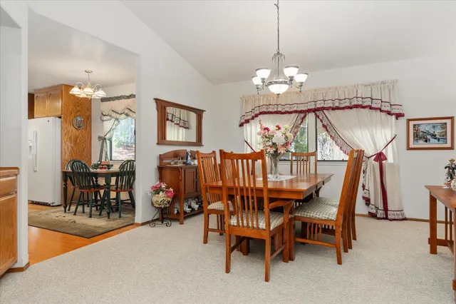 a view of a dining room with furniture and a chandelier