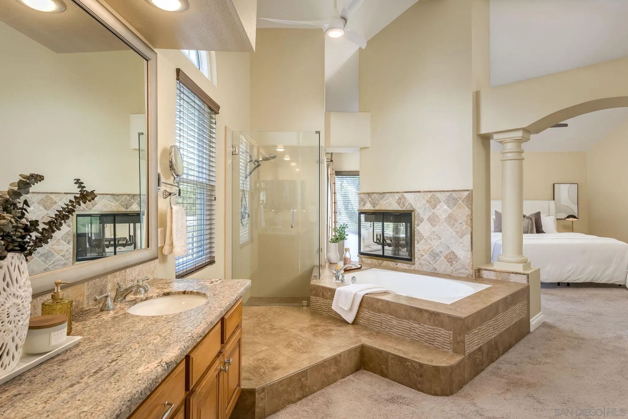 5029 Viewridge Way Oceanside, CA 92056 - Photo 16 of 31 a spacious bedroom with a granite countertop tub sink and mirror