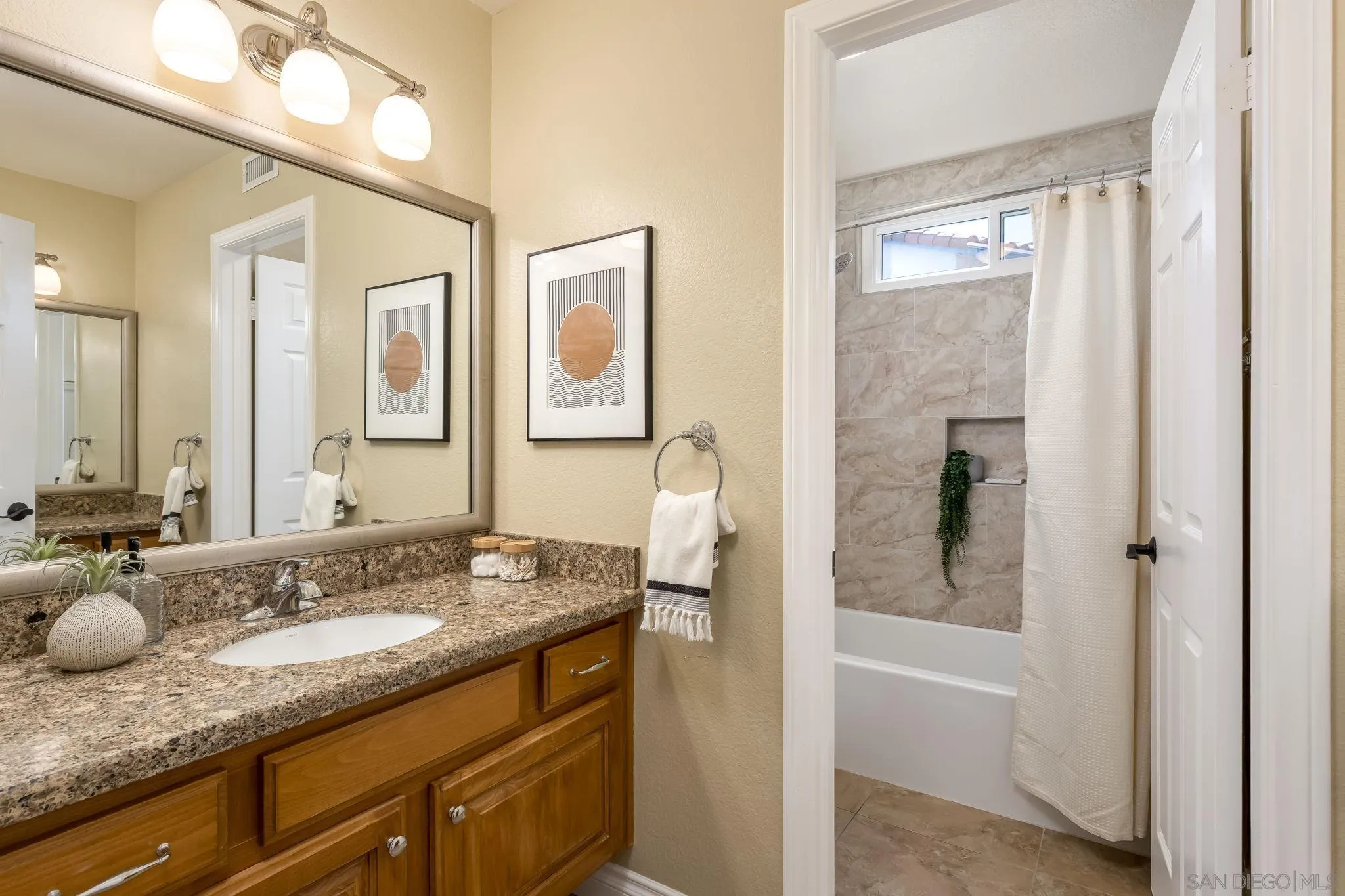 5029 Viewridge Way Oceanside, CA 92056 - Photo 18 of 31 a bathroom with a granite countertop sink tub and a mirror