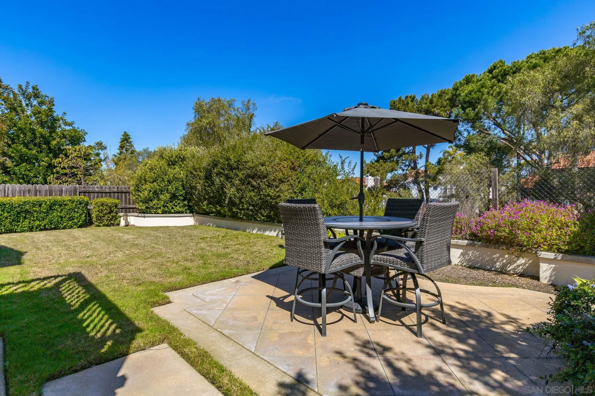 5029 Viewridge Way Oceanside, CA 92056 - Photo 22 of 31 a view of patio with chairs and table under an umbrella
