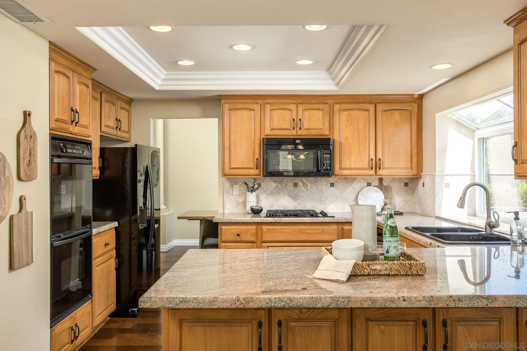 5029 Viewridge Way Oceanside, CA 92056 - Photo 6 of 31 a kitchen with stainless steel appliances granite countertop a sink a stove and a refrigerator