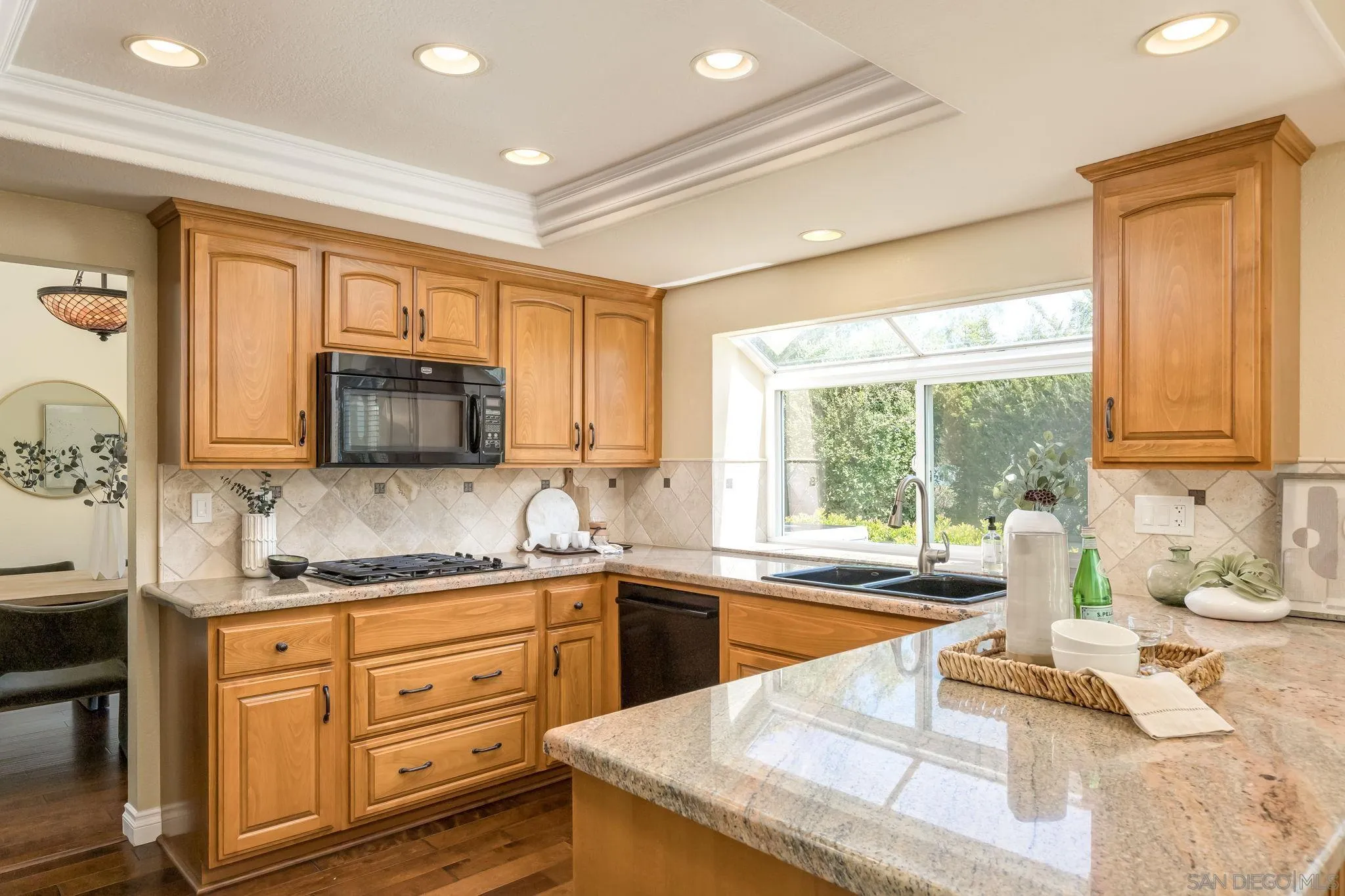 5029 Viewridge Way Oceanside, CA 92056 - Photo 7 of 31 a kitchen with granite countertop a sink and white cabinets