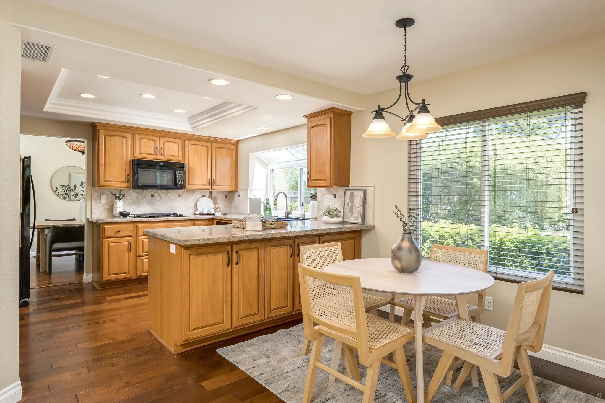 5029 Viewridge Way Oceanside, CA 92056 - Photo 8 of 31 a kitchen with granite countertop a sink dining table and chairs