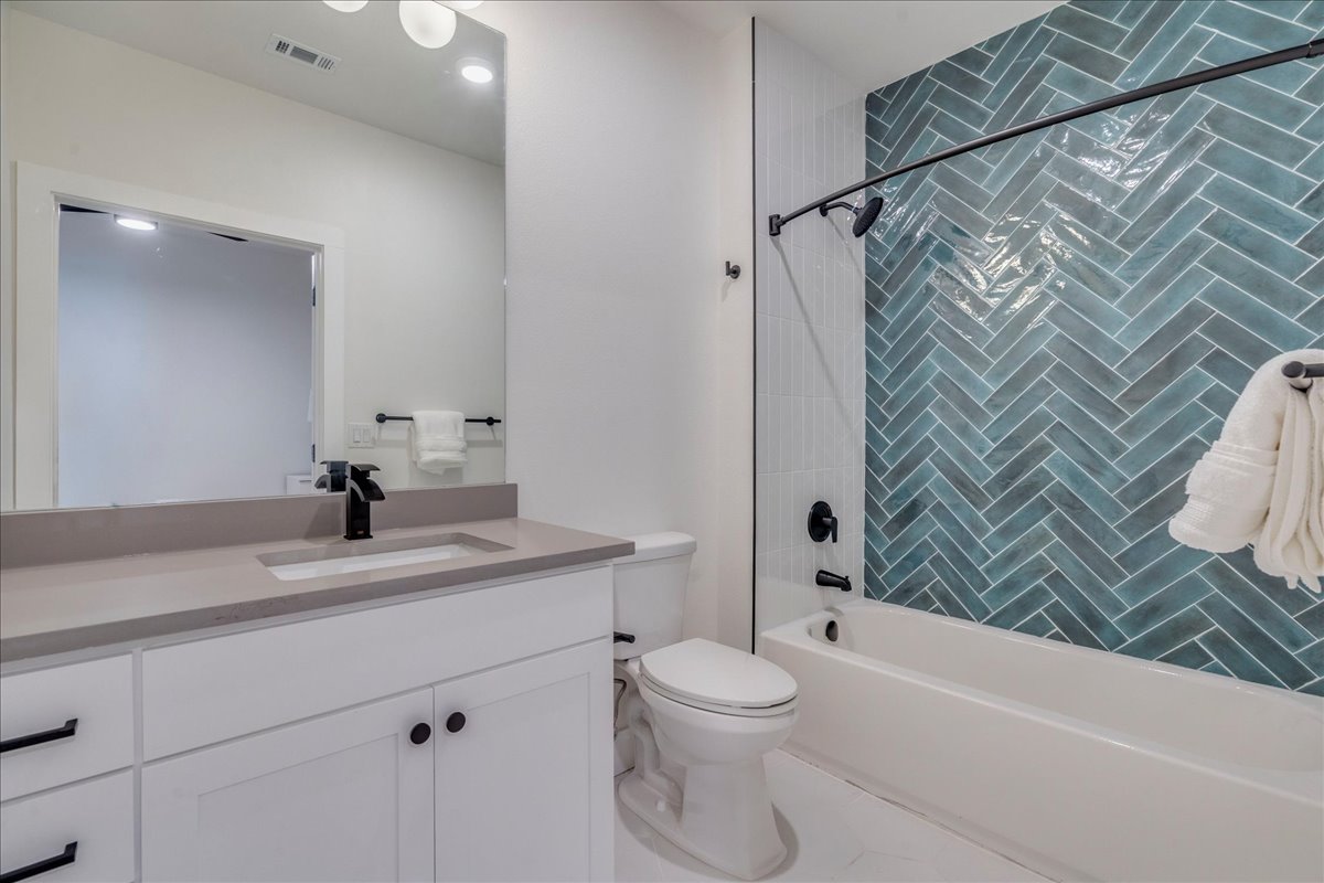 3000 Duval Street, Unit 102 Austin, TX 78705 - Photo 17 of 40 Full bath with shower / tub combination, vanity, and tile patterned floors
