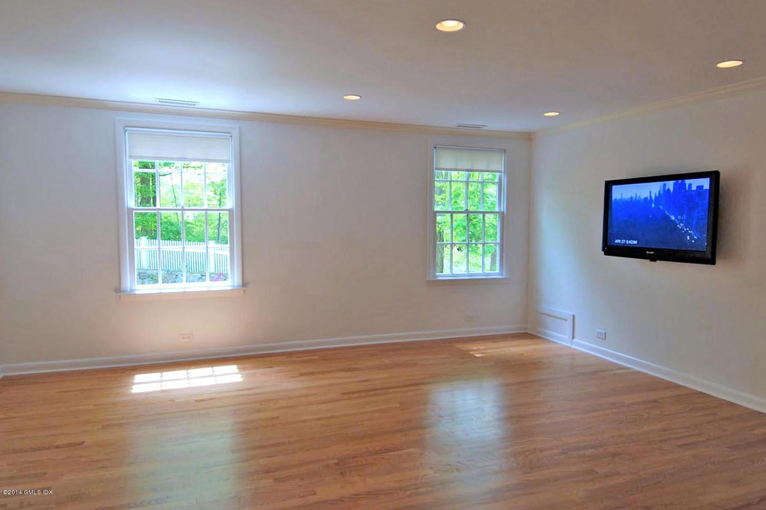 4 Ridgebrook Road Greenwich, CT 06830 - Photo 7 of 10 a view of an empty room with wooden floor and a window