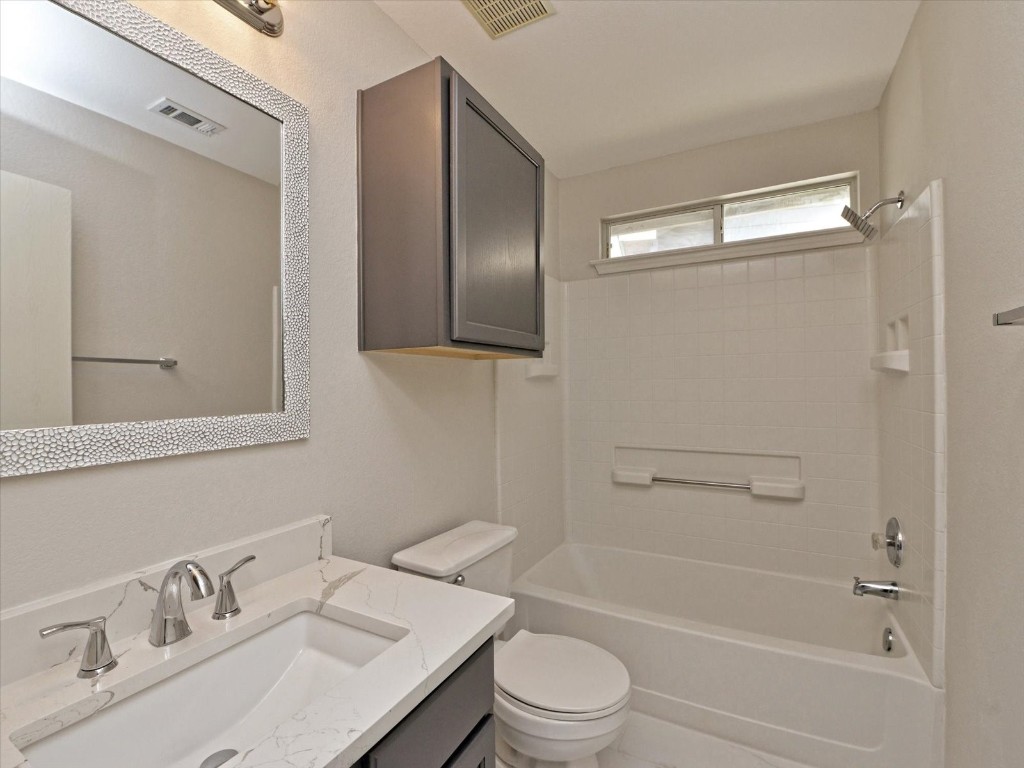 17816 Cutback Drive Manor, TX 78653 - Photo 21 of 28 a bathroom with a sink toilet and shower