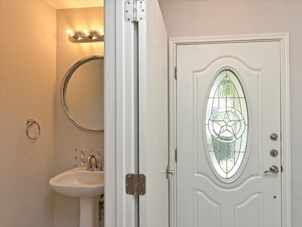 17816 Cutback Drive Manor, TX 78653 - Photo 24 of 28 a bathroom with a toilet and a sink
